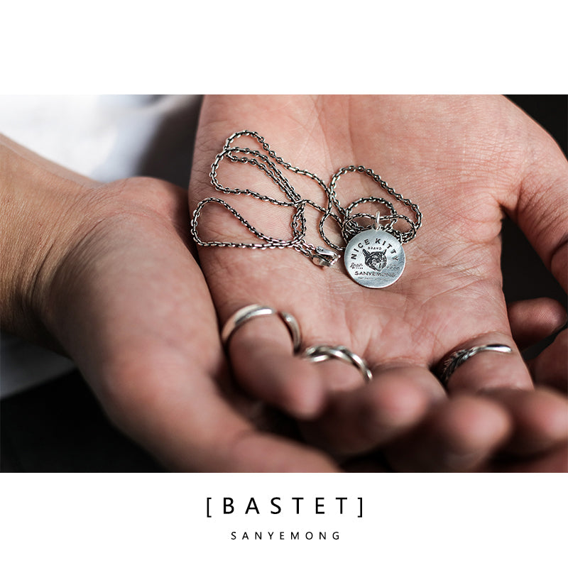 “Close-up of engraved cat tag pendant in 925 silver”