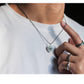 “Male model wearing minimalist unisex cat pendant necklace streetwear”
