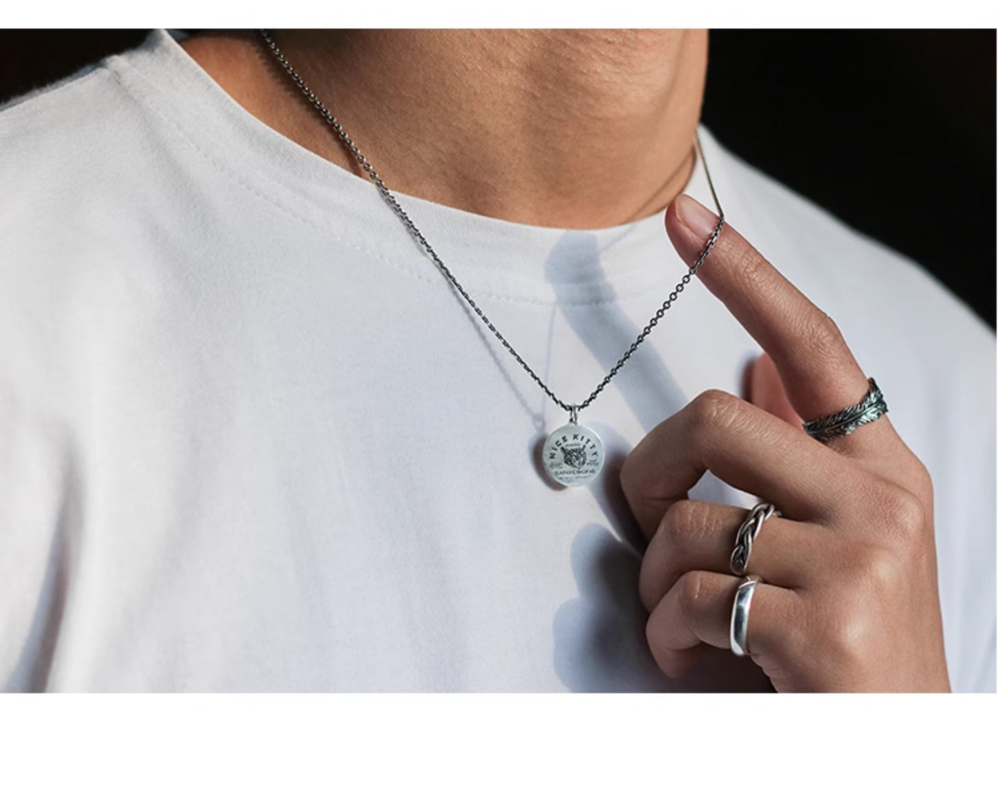 “Male model wearing minimalist unisex cat pendant necklace streetwear”