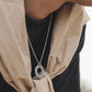 “Male model wearing dragon bone round medallion necklace streetwear style”