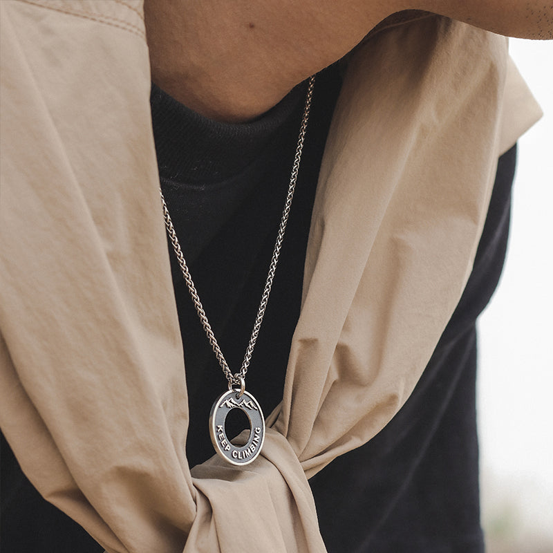 “Male model wearing dragon bone round medallion necklace streetwear style”