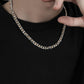 “Men’s layered silver Cuban chain necklace styled with urban streetwear outfit”