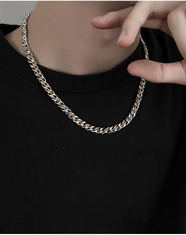 “Men’s layered silver Cuban chain necklace styled with urban streetwear outfit”