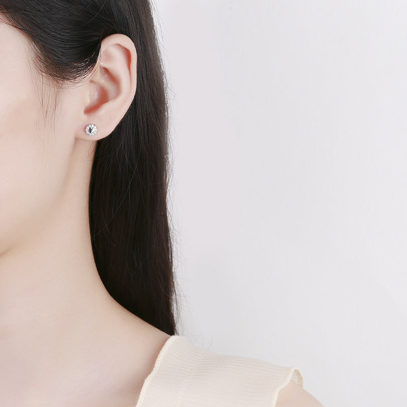 Earrings worn for everyday elegance. Alt: “Gold Sparkle: Sterling Silver Zircon Earrings.”