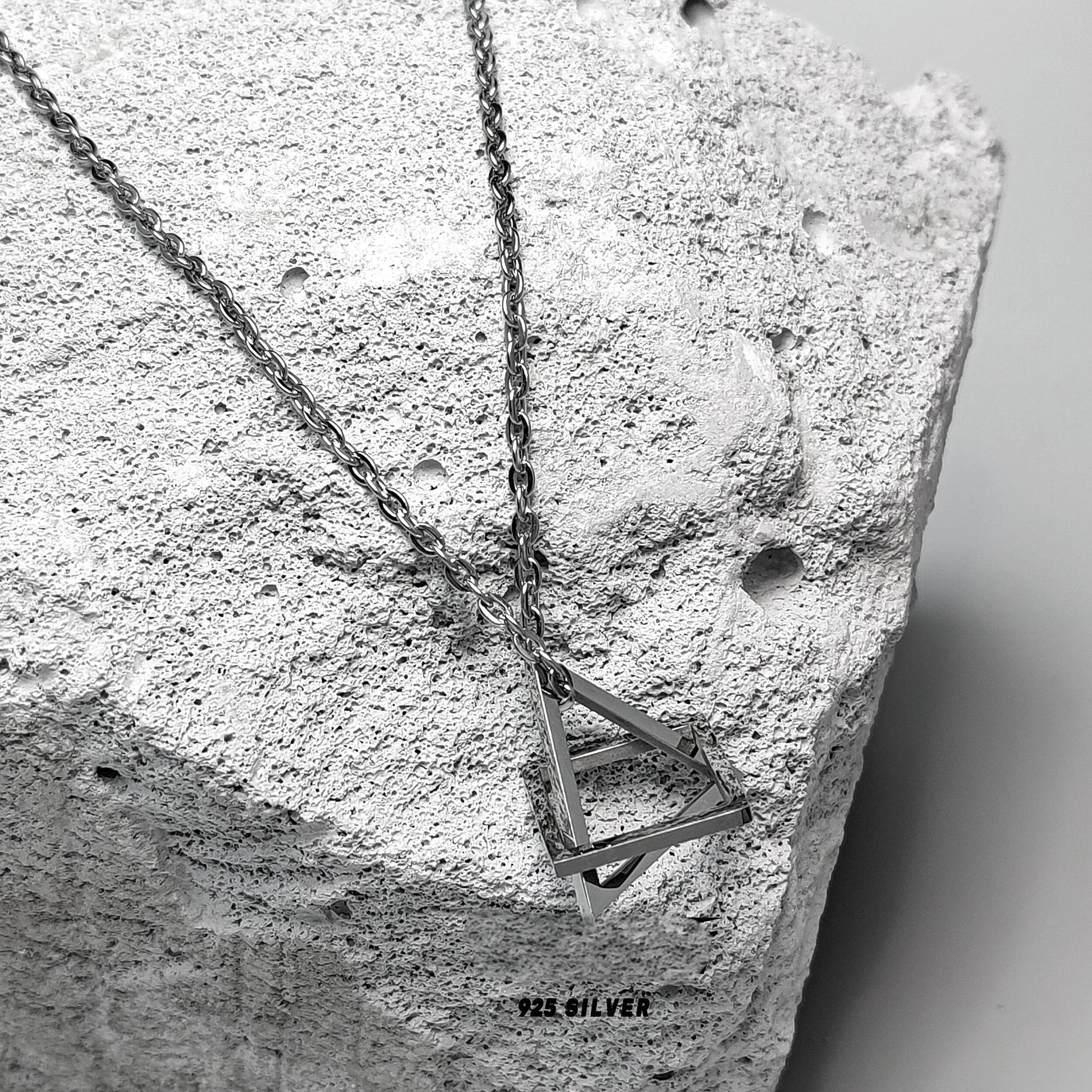 “Close-up of geometric sculptural pendant in solid sterling silver”