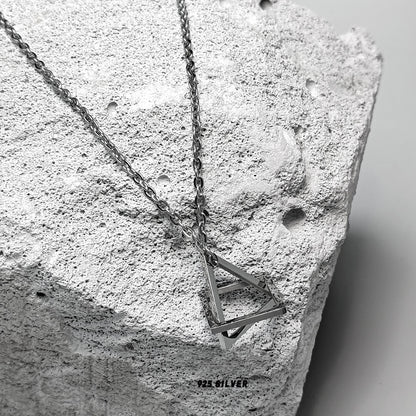 “Close-up of geometric sculptural pendant in solid sterling silver”