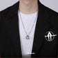“Men’s high-end geometric silver necklace styled with winter sweater outfit”