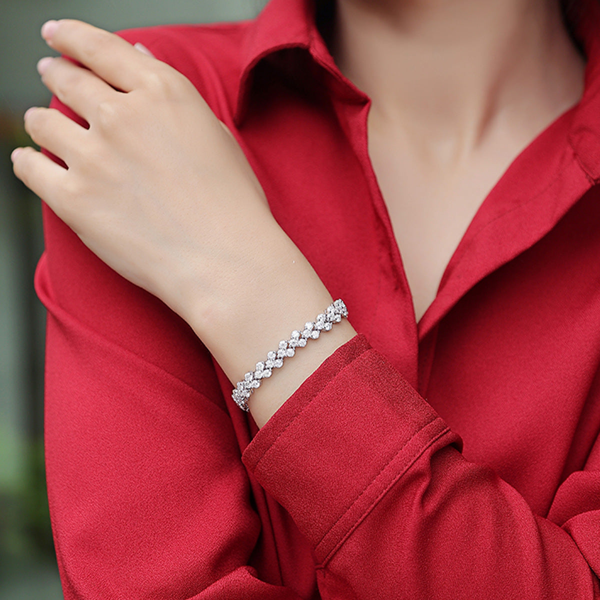  Bracelet worn as romantic statement. Alt: “Heartfelt Sparkle: Moissanite Heart Bracelet.”