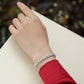  Bracelet worn as romantic statement. Alt: “Heartfelt Sparkle: Moissanite Heart Bracelet.”