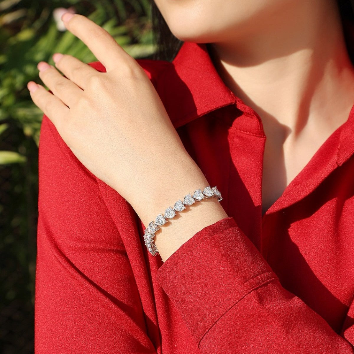 Bracelet stacked with other pieces. Alt: “Stackable Love: Heart Moissanite Bracelet.”