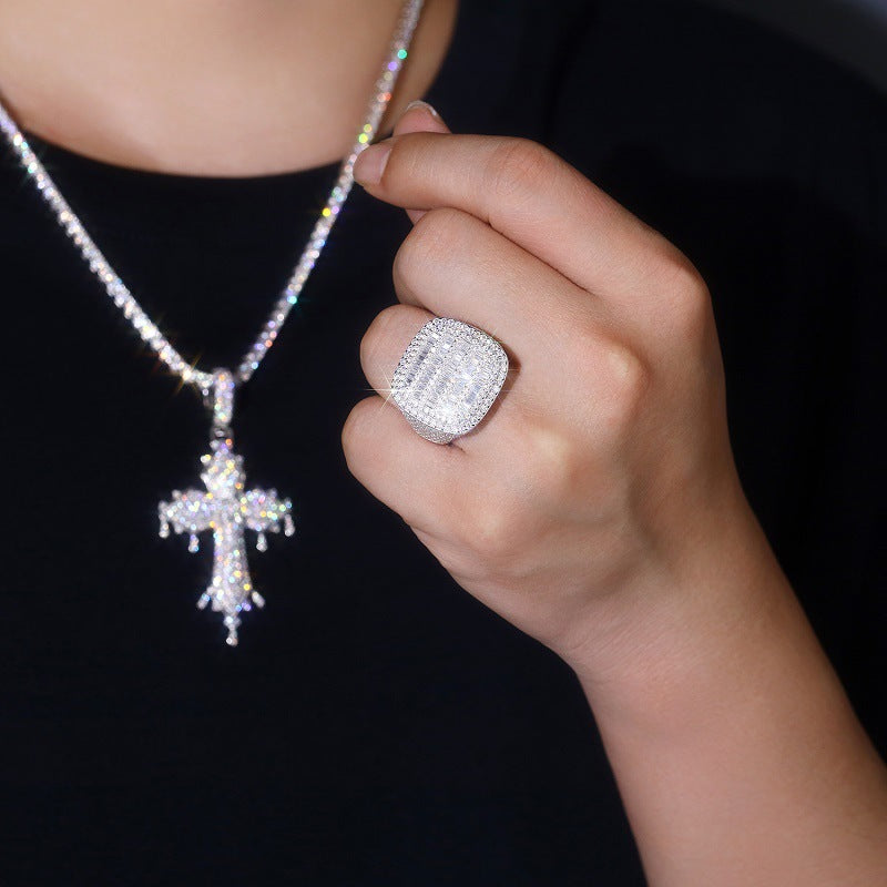 Model with contemporary streetwear (clean lines, neutral tones, luxury watch) wearing the ring.