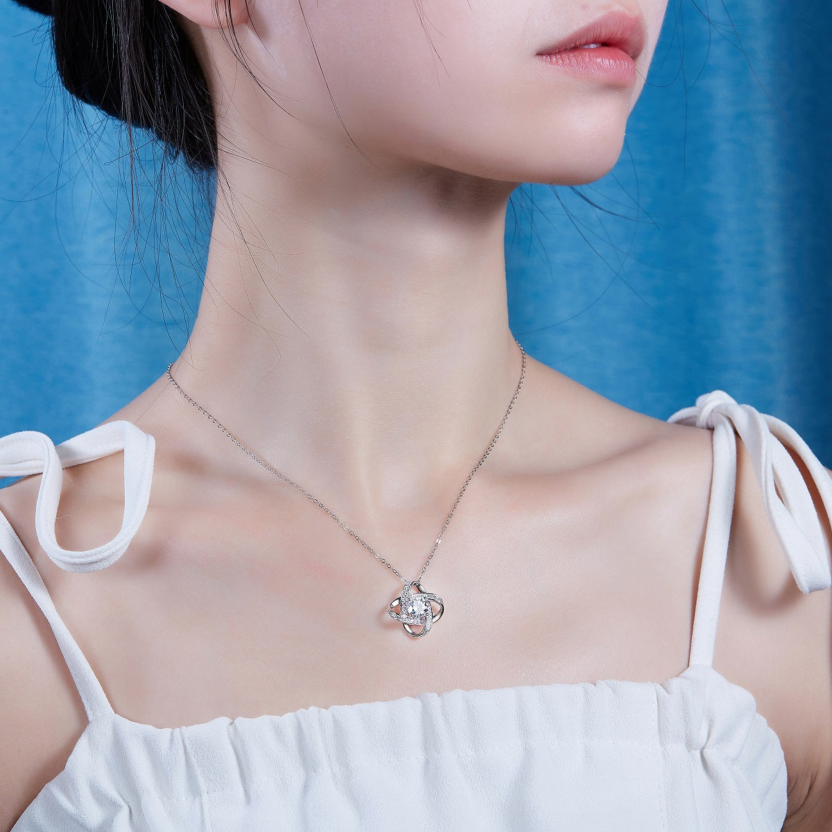 Female model wearing the necklace on bare skin or with an outfit.