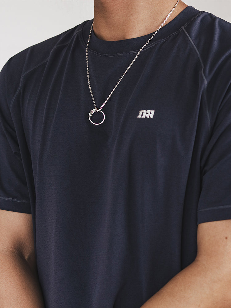 “Male model wearing minimalist Möbius infinity pendant silver necklace”