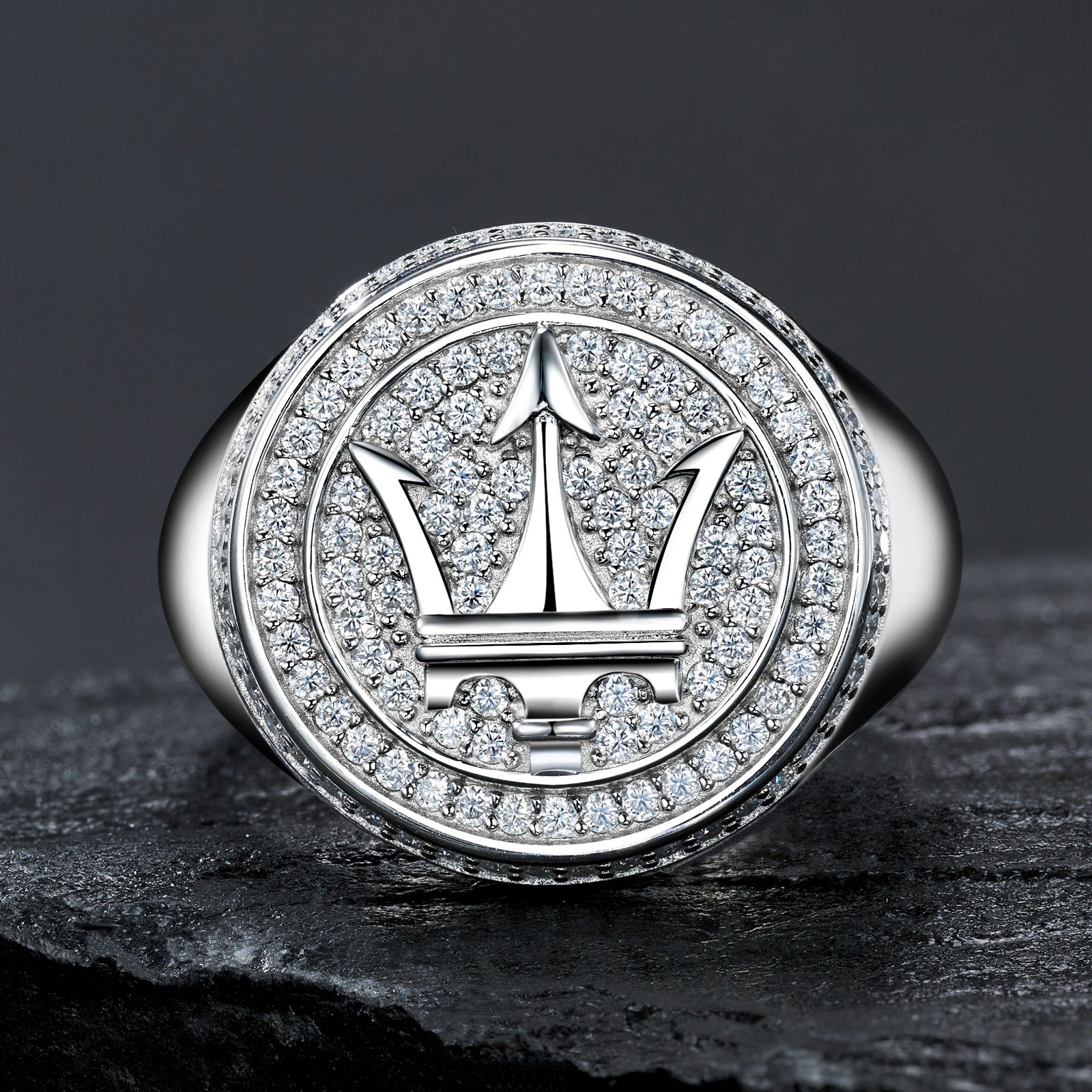 Extreme close-up of the signet top showing the precision of the Maserati trident logo.