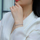 Bracelet stacked with other pieces. Alt: “Stackable Elegance: Moissanite Tennis Bracelet.”
