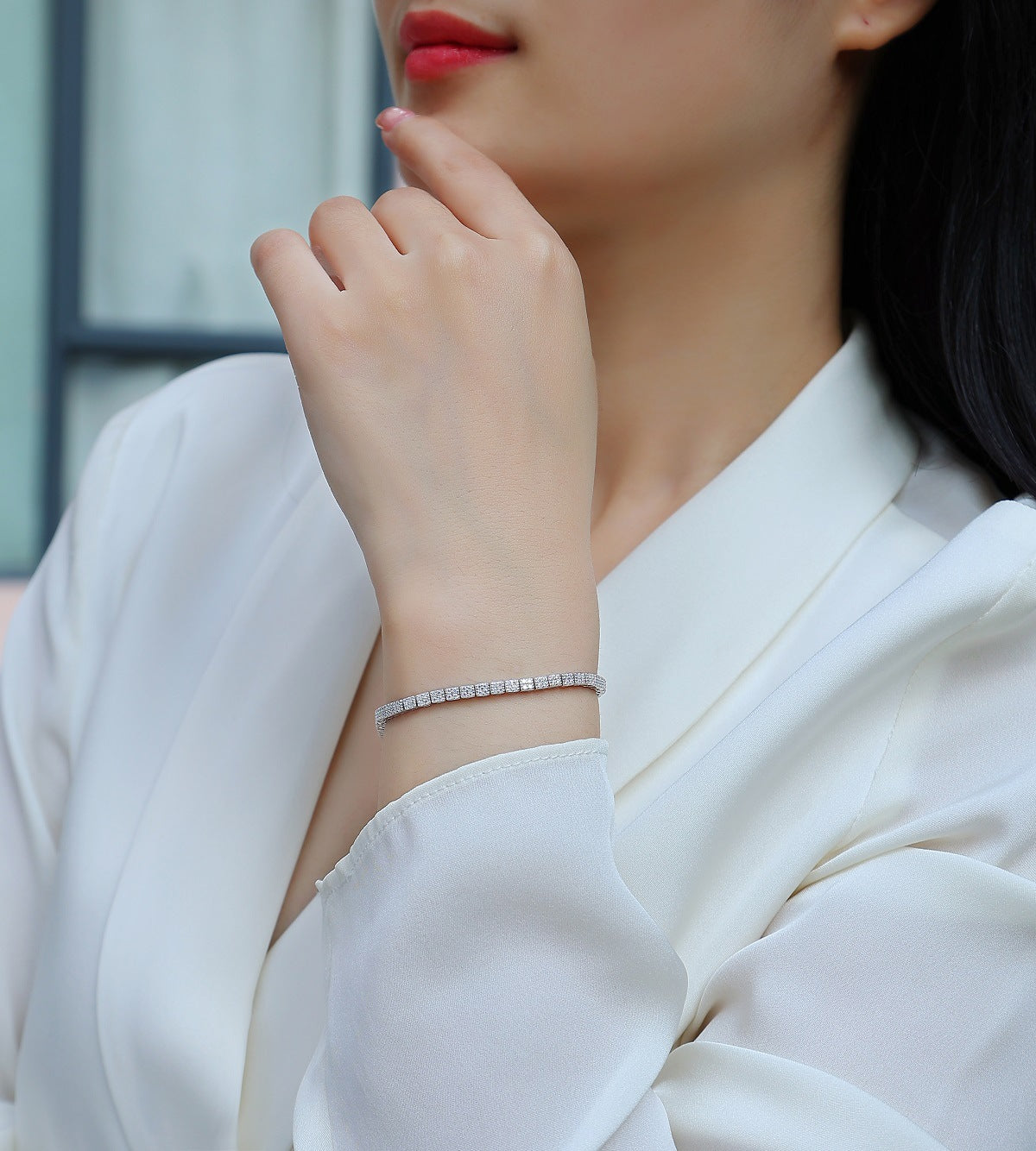 Bracelet stacked with other pieces. Alt: “Stackable Elegance: Moissanite Tennis Bracelet.”