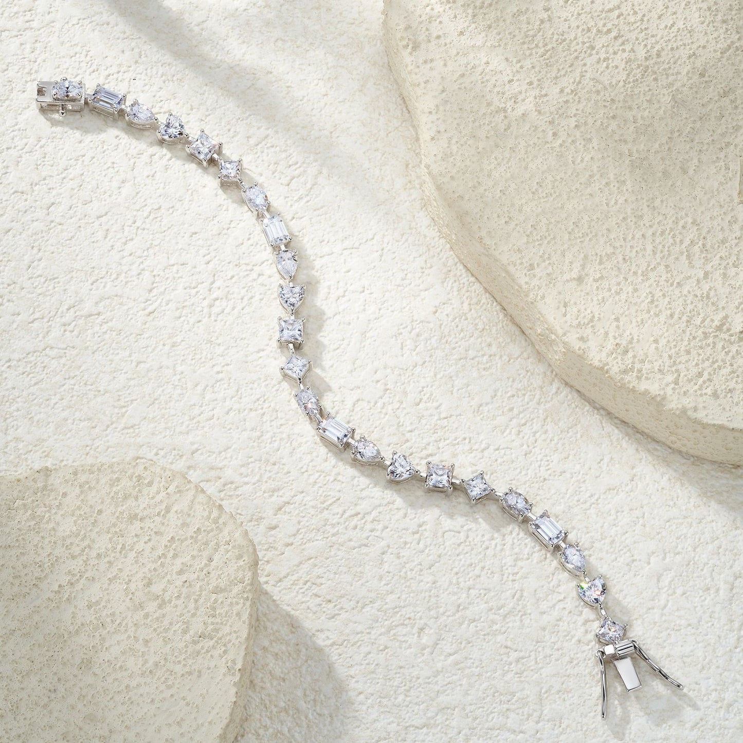 Elegant flat lay featuring 4–5 multi-shape bracelets on neutral backdrop with varied cut illustrations. Alt: “925 Sterling Silver Multi-Shape Moissanite Tennis Bracelets Collection.”