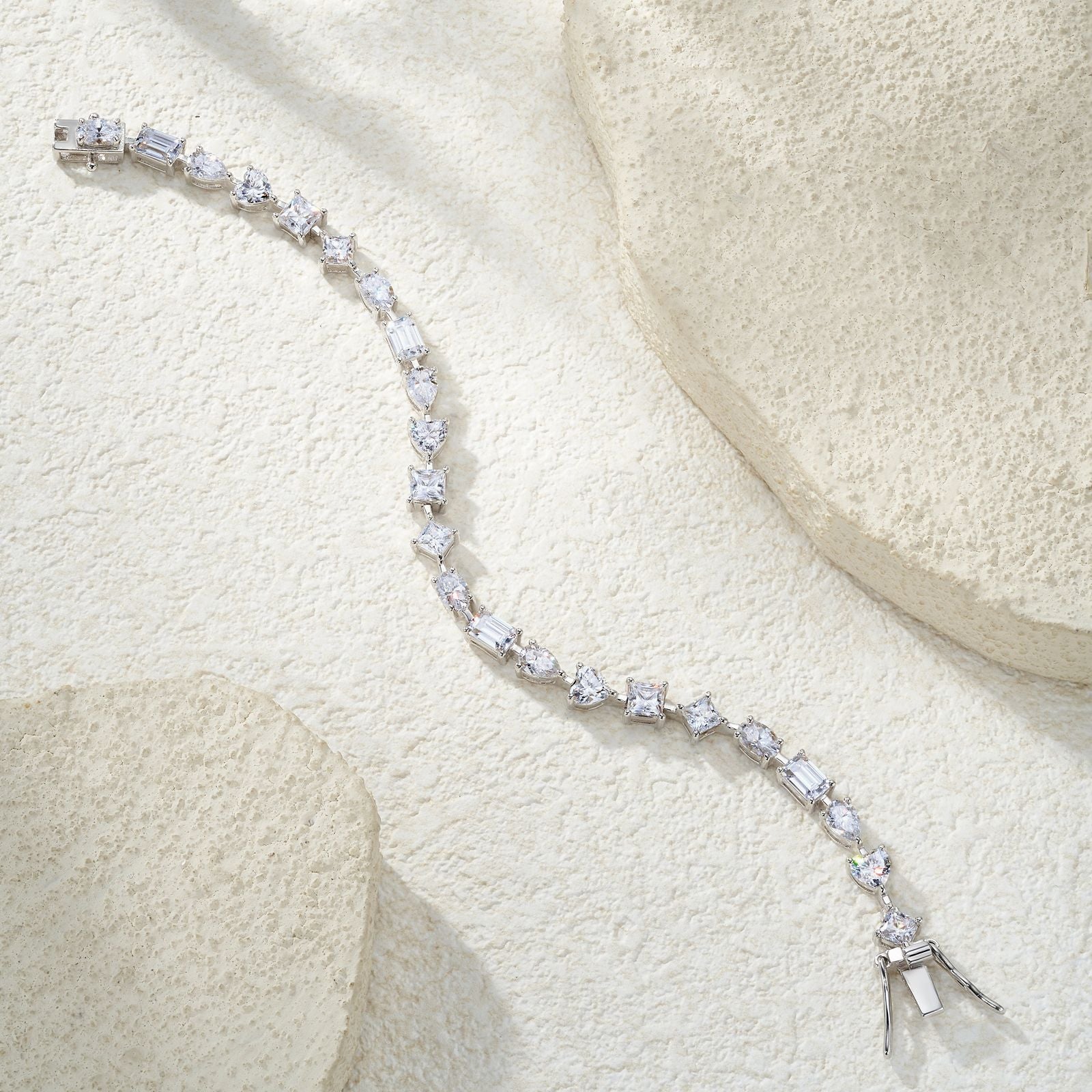 Elegant flat lay featuring 4–5 multi-shape bracelets on neutral backdrop with varied cut illustrations. Alt: “925 Sterling Silver Multi-Shape Moissanite Tennis Bracelets Collection.”