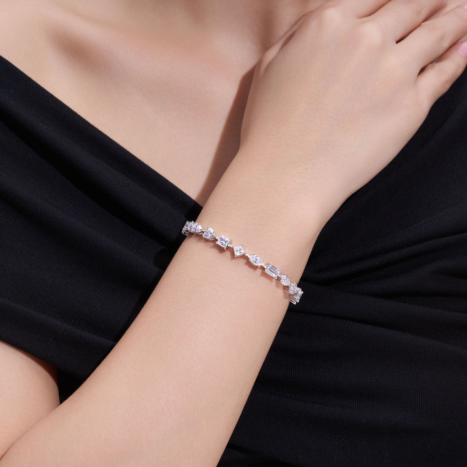 Elegant flat lay featuring 4–5 multi-shape bracelets on neutral backdrop with varied cut illustrations. Alt: “925 Sterling Silver Multi-Shape Moissanite Tennis Bracelets Collection.”