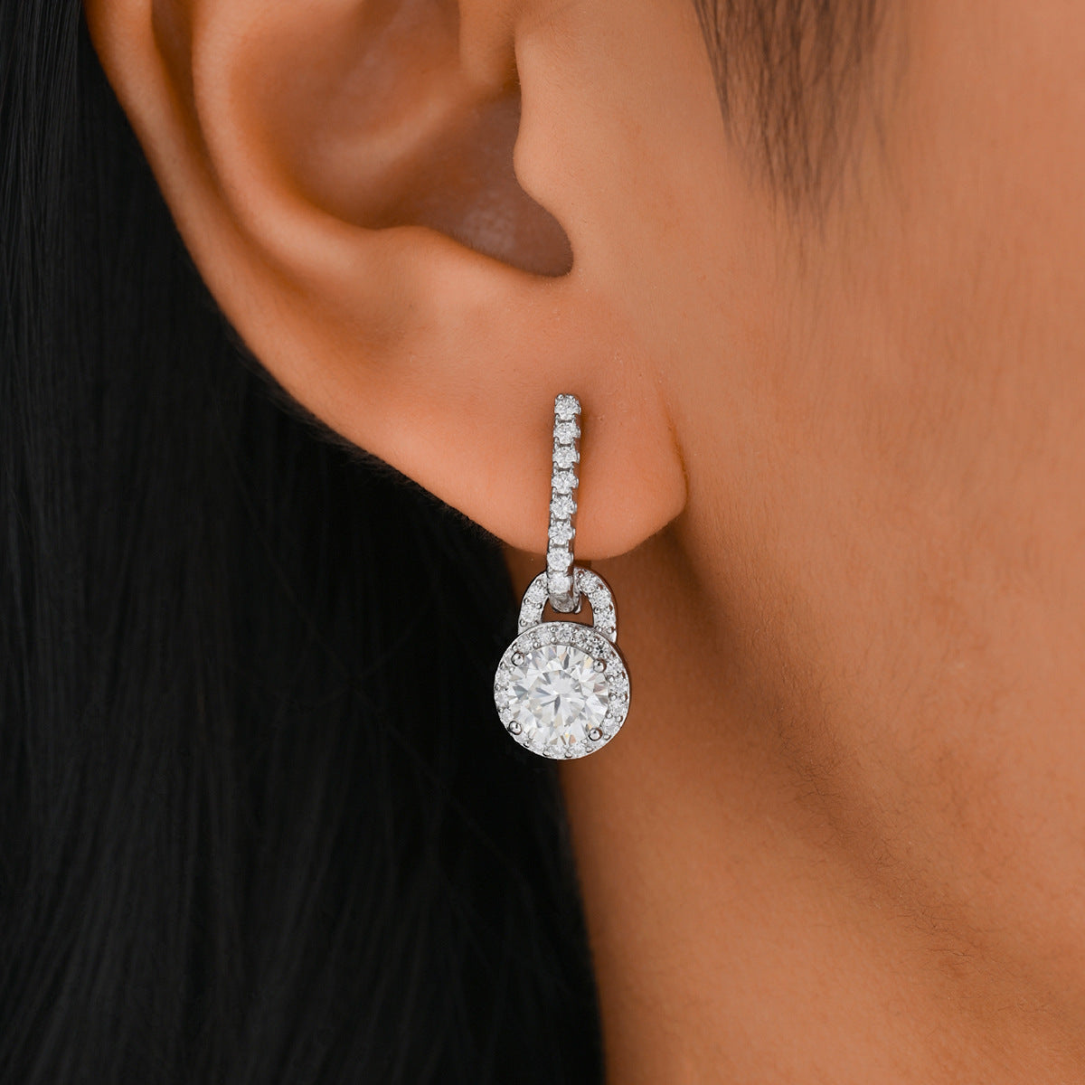 Earrings worn as graceful dangles. Alt: “Elegance in Motion: Moissanite Drop Earrings.”