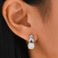 Earrings worn as symbolic statement. Alt: “Endless Sparkle: Infinity Moissanite Earrings.”