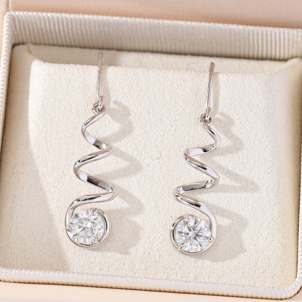 Yellow gold spiral moissanite hoops on neutral background. Alt: “Spiral Pavé Moissanite Hoops – 18K Yellow Gold.”


