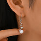 Yellow gold spiral moissanite hoops on neutral background. Alt: “Spiral Pavé Moissanite Hoops – 18K Yellow Gold.”

