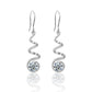 Yellow gold spiral moissanite hoops on neutral background. Alt: “Spiral Pavé Moissanite Hoops – 18K Yellow Gold.”

