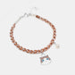 Bracelet with a cat charm on a white background