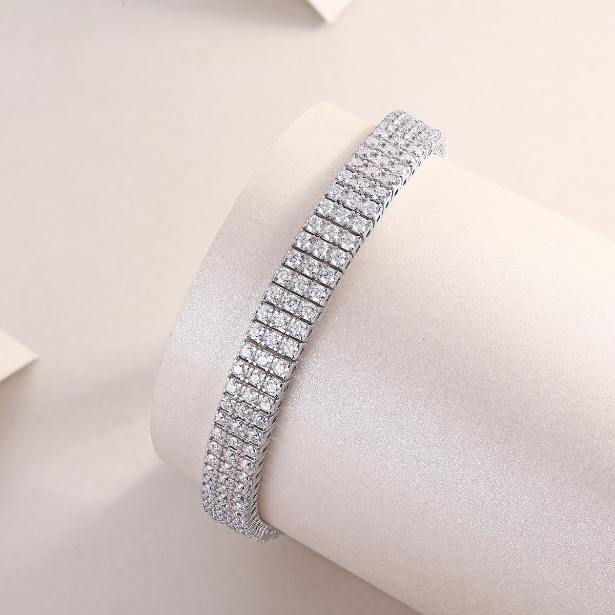 White gold three-row moissanite bracelet on neutral background. Alt: “Multi-Row Moissanite Bracelet – White Gold.”