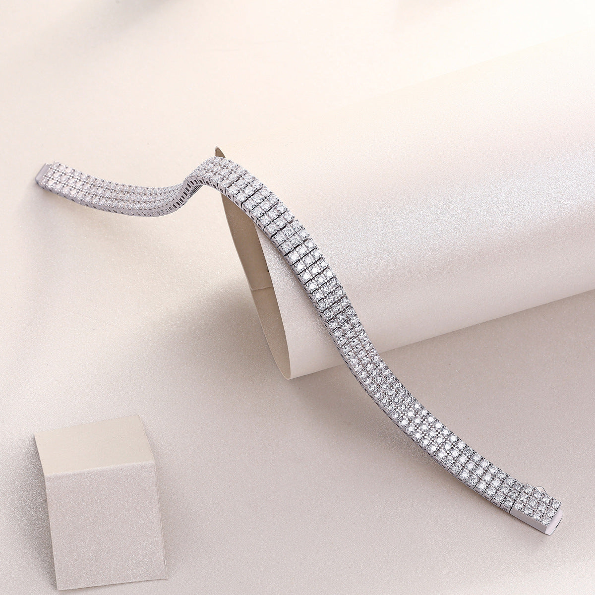 White gold three-row moissanite bracelet on neutral background. Alt: “Multi-Row Moissanite Bracelet – White Gold.”