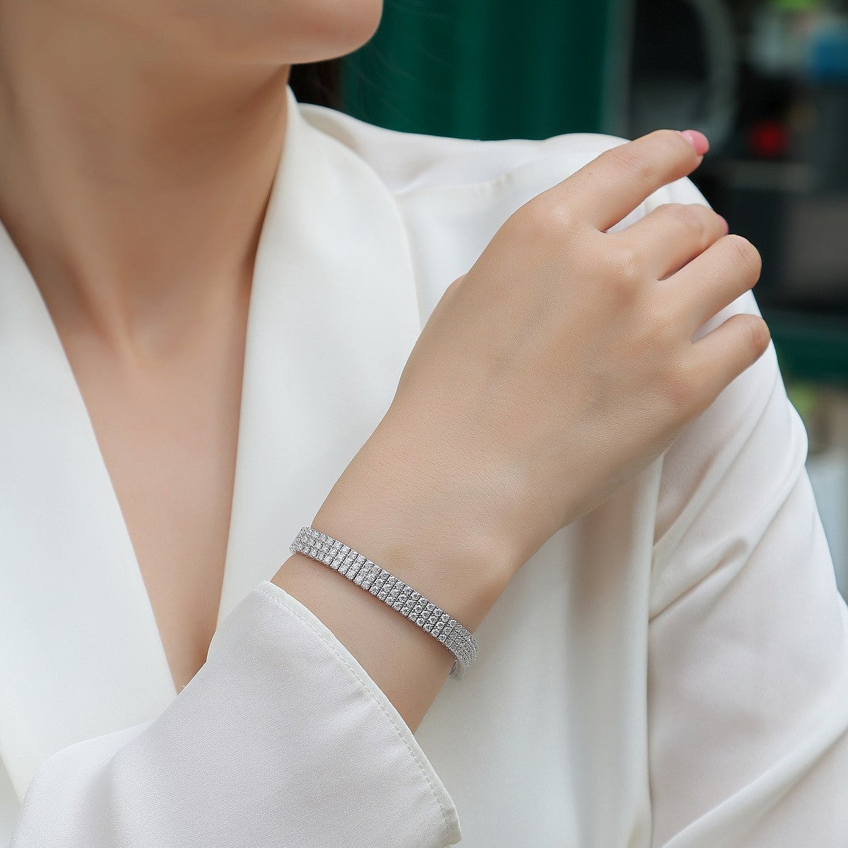 Bracelet worn as elegant statement. Alt: “Triple Brilliance: Three-Row Moissanite Bracelet.”