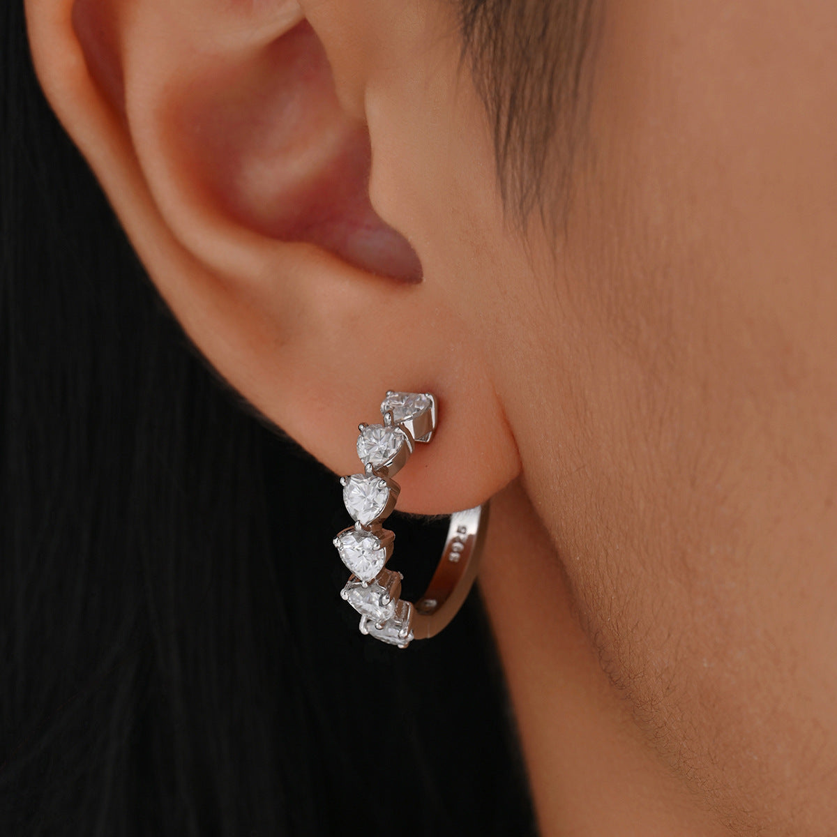 Earrings worn as romantic statement. Alt: “Heartfelt Sparkle: Moissanite Heart Earrings.”