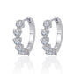 Yellow gold 8mm heart moissanite studs on neutral background. Alt: “8mm Heart Moissanite Earrings – 18K Yellow Gold.”