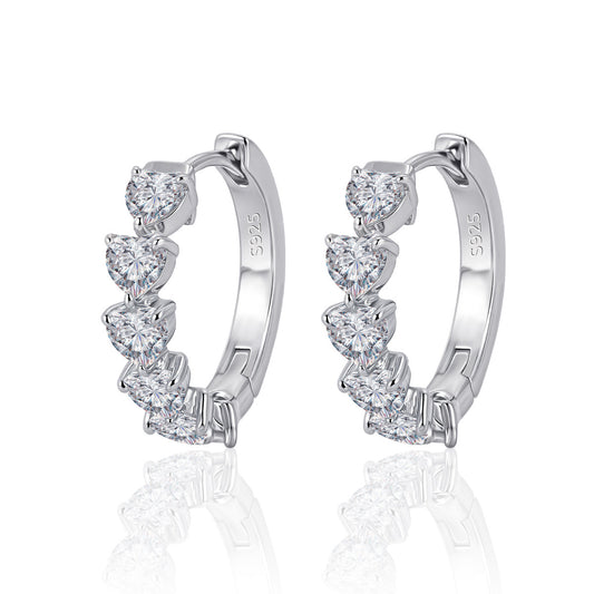 Yellow gold 8mm heart moissanite studs on neutral background. Alt: “8mm Heart Moissanite Earrings – 18K Yellow Gold.”