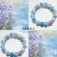 Colorful beaded bracelet with 'ZERRA' branding against a scenic background