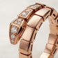 A close-up of a rose gold bracelet featuring a distinctive snake-head link design embellished with clear pavé and round diamonds, set against a clean light gray background.