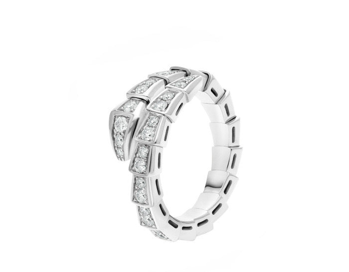 A silver-toned snake ring featuring channel-set round and baguette diamonds, presented on a clean white background.