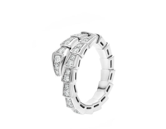A silver-toned snake ring featuring channel-set round and baguette diamonds, presented on a clean white background.