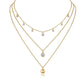Clean white background — the round moissanite solitaire and polished ball pendant, each on its own chain, layered elegantly on a bust form. The round solitaire catches bright light with classic brilliant sparkle, while the ball pendant offers a smooth, reflective contrast. 