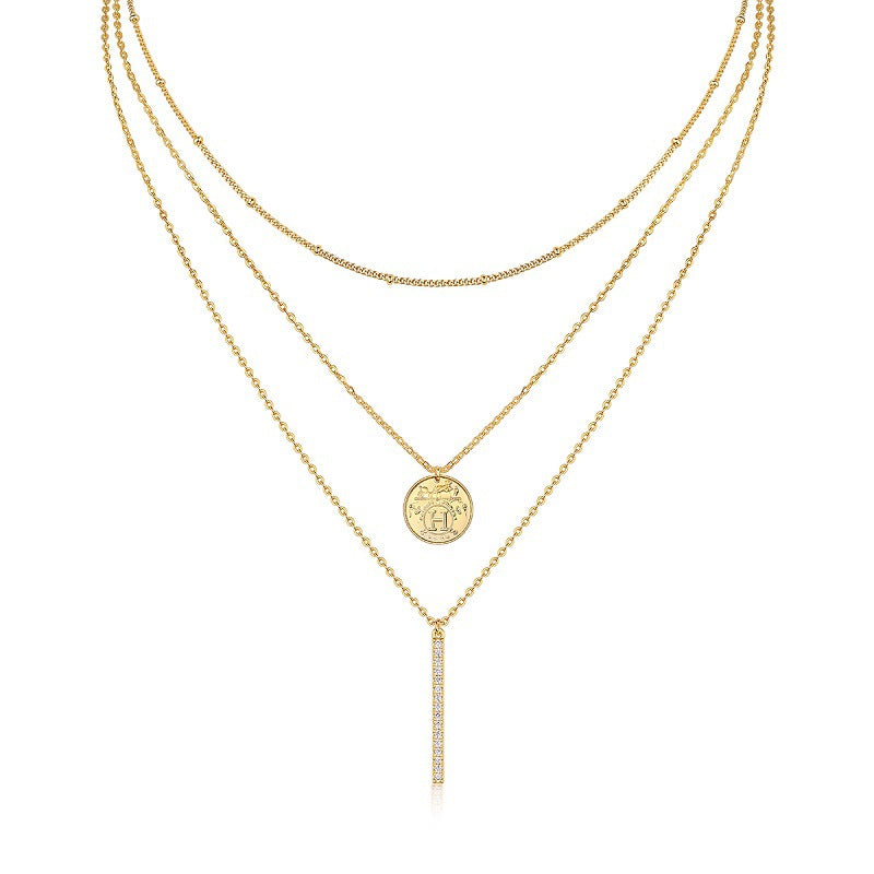 Clean white background — both necklaces layered elegantly on a bust form. The moissanite bar catches soft light, showing subtle sparkle; the polished coin pendant sits slightly lower. Chains drape smoothly without tangling.