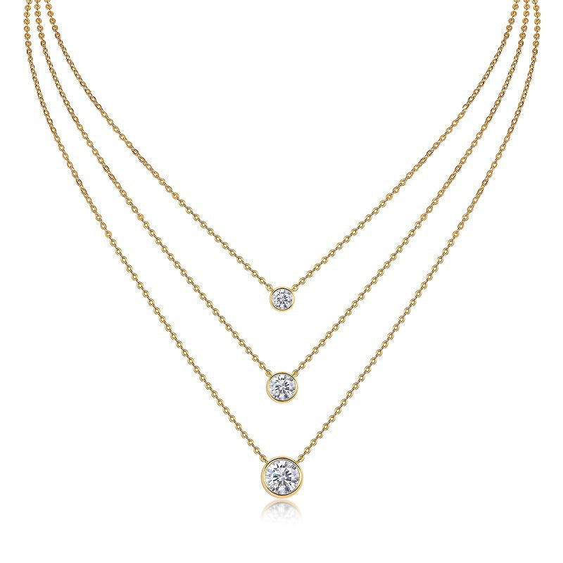 Clean white background — the bezel set moissanite pendant layered with 2-3 mixed chains on a bust form. The solitaire catches light, showcasing the round brilliant cut’s fire while the sleek metal rim creates a clean, modern frame. Chains vary in texture for balanced visual interest.