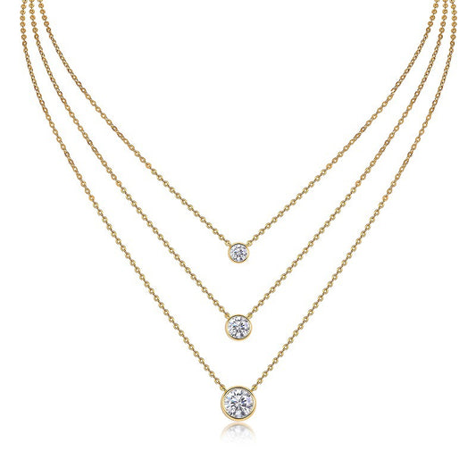 Clean white background — the bezel set moissanite pendant layered with 2-3 mixed chains on a bust form. The solitaire catches light, showcasing the round brilliant cut’s fire while the sleek metal rim creates a clean, modern frame. Chains vary in texture for balanced visual interest.