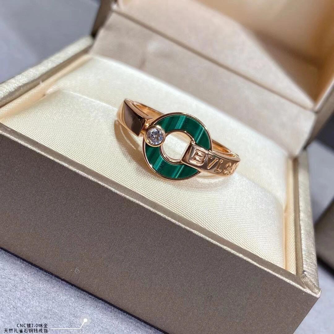 Gold ring with green stone in a jewelry box