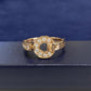 Gold ring with diamond accents on a blue background