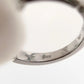 Close-up of a silver bracelet with visible hallmarking on a white background