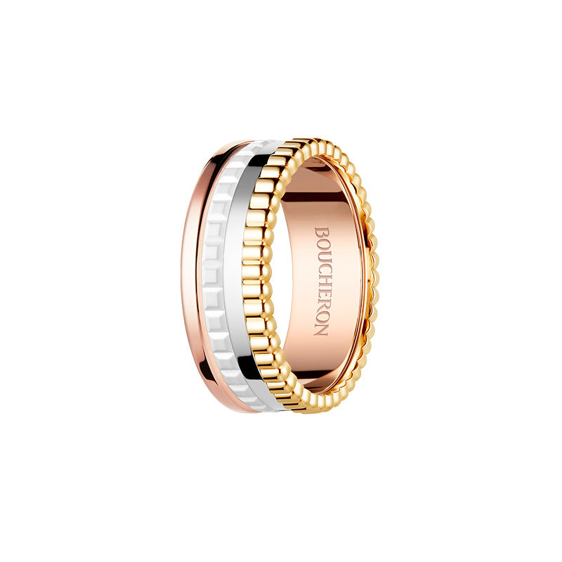 Two-tone gold and rose gold ring with 'BOUCHERON' branding on a white background