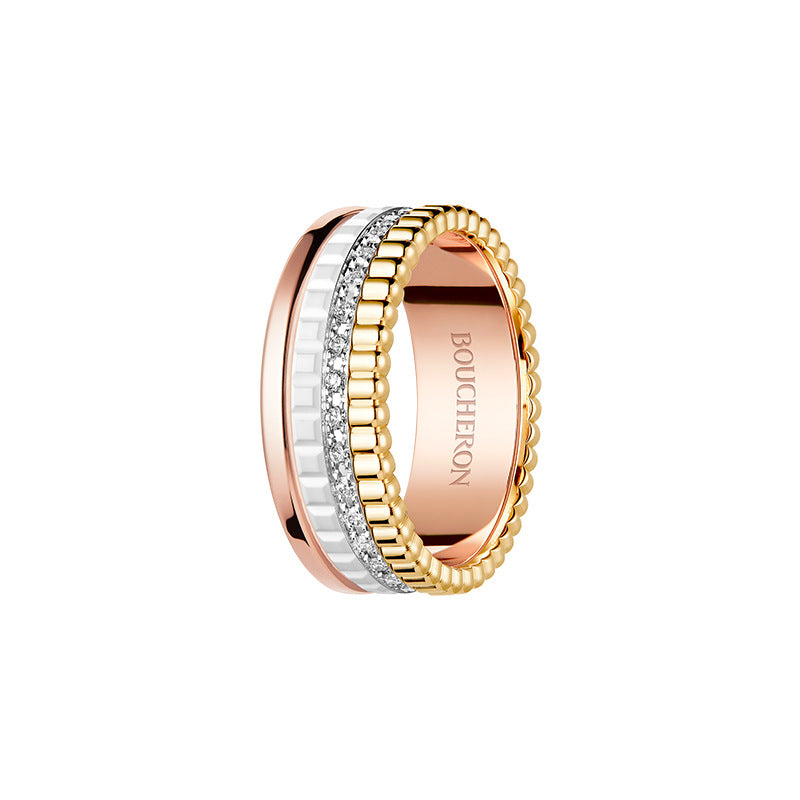 Three-toned ring with rose gold, white gold, and yellow gold bands on a white background.