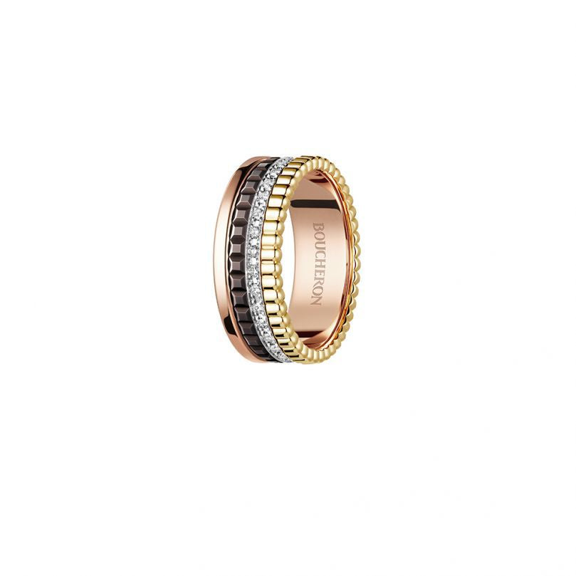Gold and rose gold ring with diamond accents on a white background