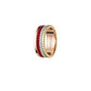 Gold ring with red and white accents on a white background